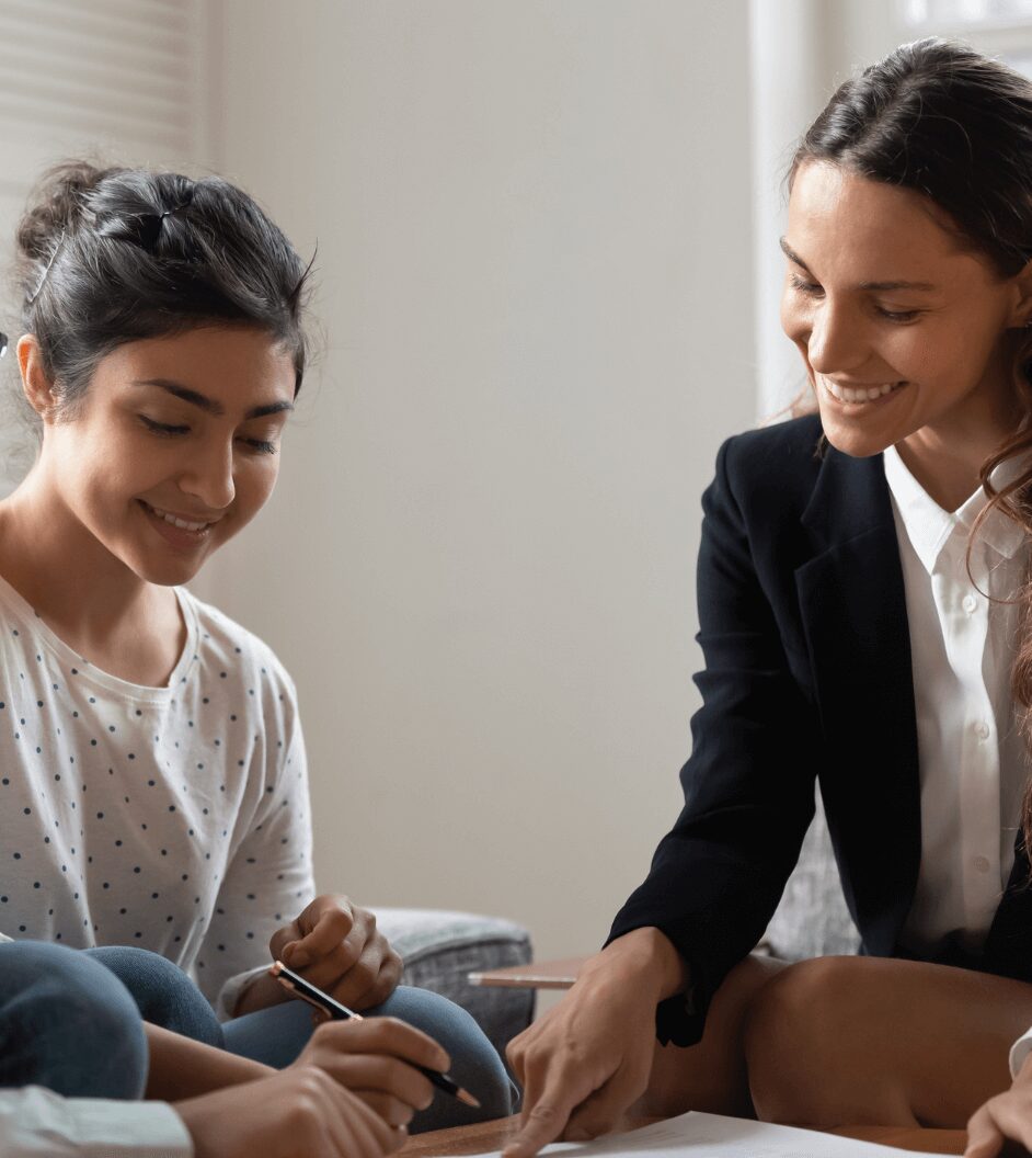 Agent guiding a young client with paperwork