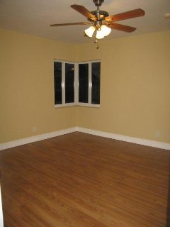 Bright room with ceiling fan and windows.